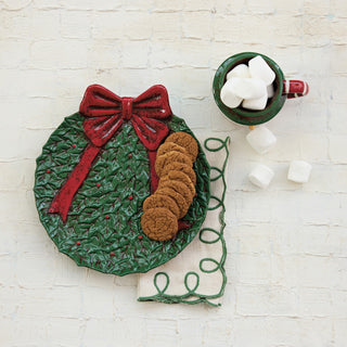 Hand-painted ceramic wreath shaped plate with bow in green and red by Creative Co-op
